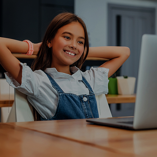 image of a boy studying online using laptop